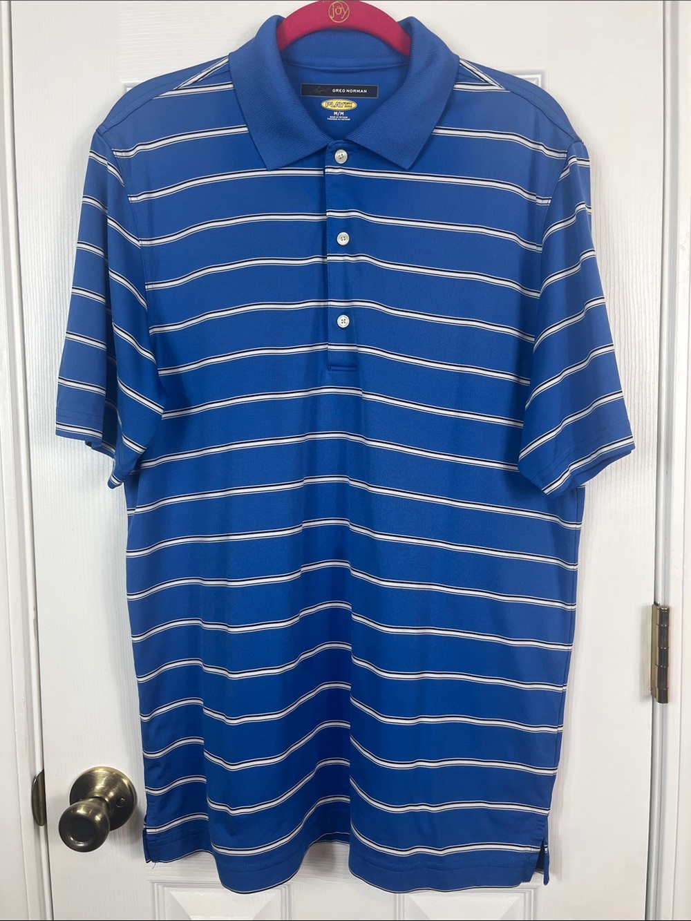Greg Norman blue w/small stripes, short sleeved. Size medium polo shirt